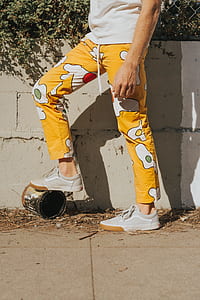 person in yellow pants and gray Vans shoes thumbnail