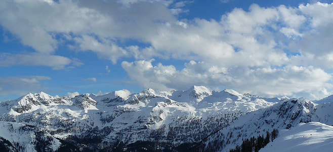 landscape photography of mountain alps under cumulus clouds thumbnail