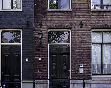 black wooden door on brown brick building thumbnail