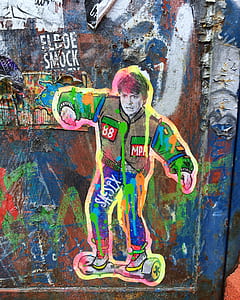 man riding self-balancing board graffiti thumbnail