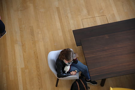 woman sitting on chair near dining table thumbnail