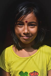 smiling girl wearing yellow shirt thumbnail
