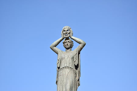 woman carrying mask statue thumbnail