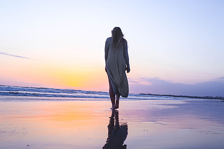woman walking on shore thumbnail