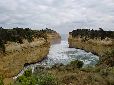 bird's-eye view of sea stack under cloudy sky thumbnail