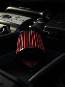 close-up photo of black and red air intake on black surface thumbnail