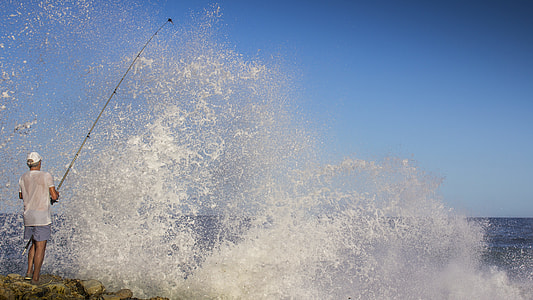 man catching fish using fishing rod during daytmie thumbnail