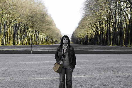 grayscale of woman standing on road thumbnail