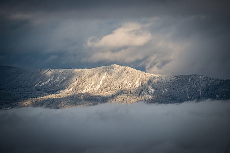aerial view photography of mountain under cloudy sky thumbnail