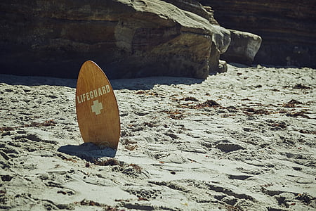 brown Lifeguard skimboard on gray sand thumbnail