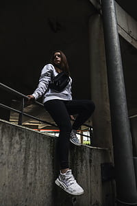 woman sitting on handrail near bridge thumbnail