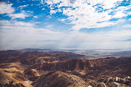 aerial photography of mountain below white skyt thumbnail