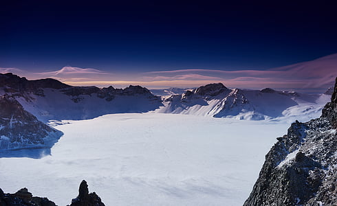 areal photography of snowfield near mountain thumbnail