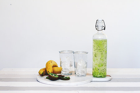 clear glass bottle with green liquid thumbnail