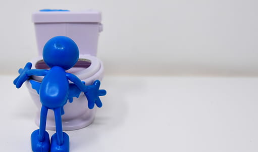blue plastic toy near white ceramic toilet bowl thumbnail