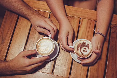 Two People Holding White Cup With Coffee thumbnail
