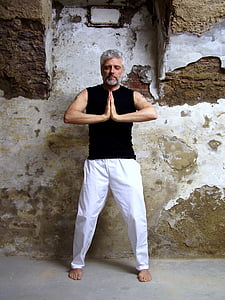 man standing near gray and white wall inside room thumbnail