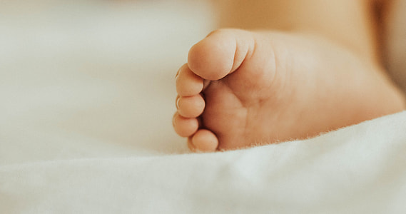 toddler's foot shallow focus photography thumbnail