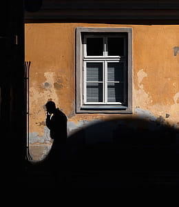silhouette of man near brown concrete building thumbnail