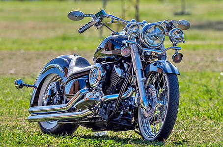 black and chrome motorcycle on grass during daytime thumbnail