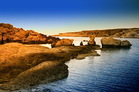 rock formation near body of water thumbnail