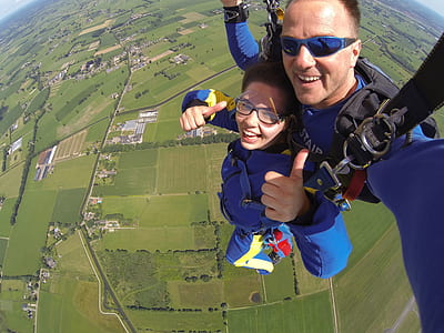 Couple in Blue Suit Paragliding thumbnail