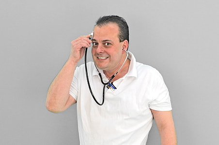 person wearing white polo shirt holding stethoscope while putting it in his forehead thumbnail