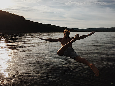 person jump into body of water during daytime thumbnail