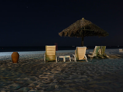 four white sun loungers on seashore thumbnail