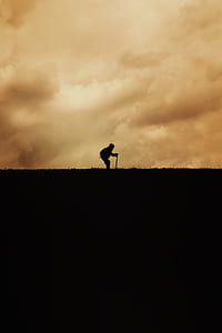 man standing under the cloudy sky thumbnail