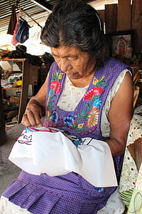 woman in purple and white dress sewing thumbnail