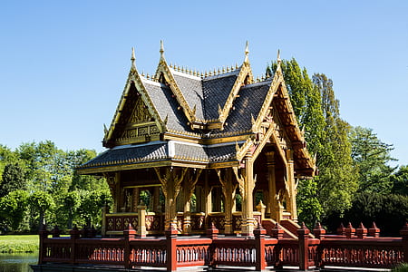 brown and black concrete pagoda near trees thumbnail