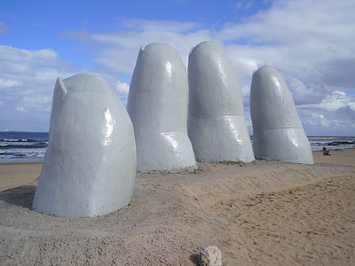 hand monument near beach at daytime thumbnail