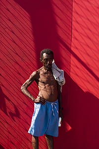 man standing near wall during daytime thumbnail