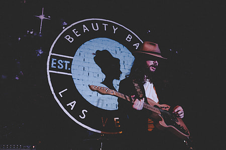 man playing guitar on stage thumbnail