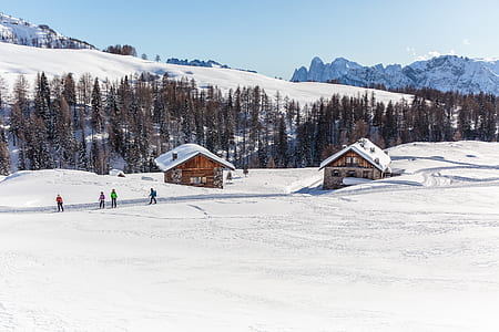 four people near cabin covered with snow thumbnail