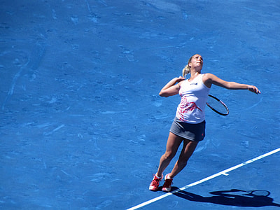 woman to swing red tennis racket outdoors thumbnail