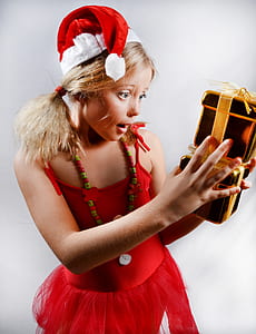 girl holding gold gift boxes thumbnail