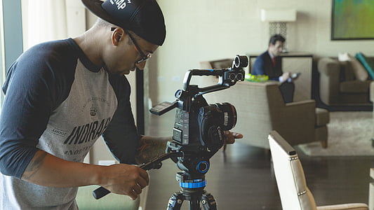 man holding video camera thumbnail