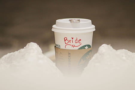 person showing Starbucks Coffee cup thumbnail