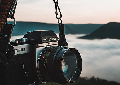 selective focus photography of black and gray Minolta DSLR camera thumbnail