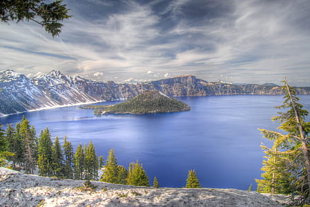 landscape photo of island during nimbus clouds thumbnail