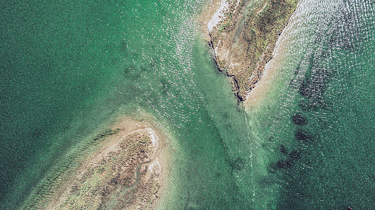 aerial photography of island with ocean water view during daytime thumbnail