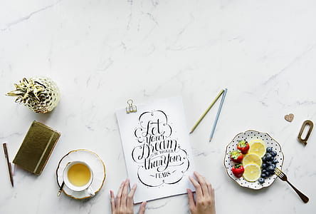 person holding white cook book thumbnail