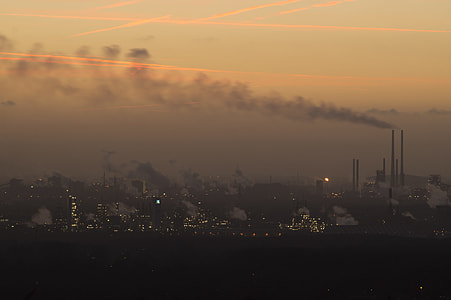silhouette of buildings and factories during sunset thumbnail