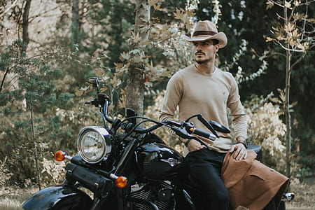 man riding on at motorcycle near green plants thumbnail