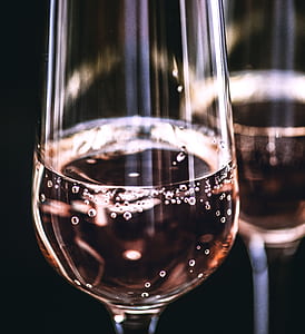 two clear champagne glasses with brown carbonated beverage thumbnail