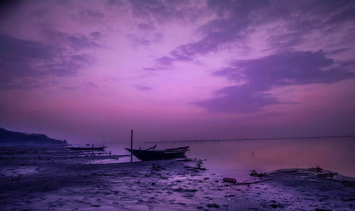 boat on seashore during daytime thumbnail