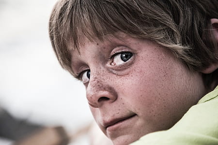 selective focus photo of boy wearing yellow top thumbnail