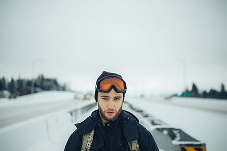 man standing on snow covered street thumbnail